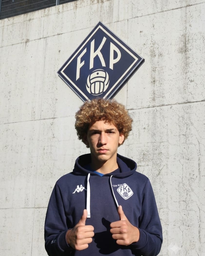 One of the Hernandez brothers in front of the FK Pirmasens crest
